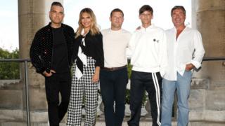 Robbie Williams, Ayda Field, host Dermot O'Leary, Louis Tomlinson and Simon Cowell pose during The X Factor 2018 launch at Somerset House on July 17,