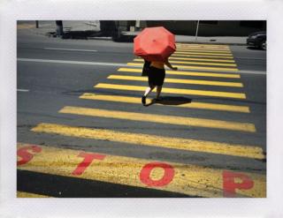 Woman with umbrella using a street crossing in Yerevan, Armenia