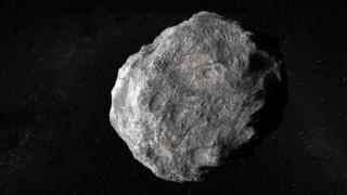 An illustration of a grey/white asteroid on a starfield