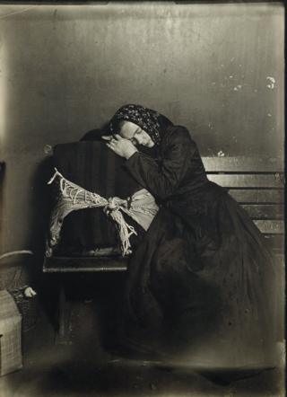 An immigrant sleeps on her case.
