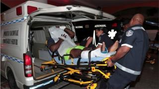 An injured inmate is carried on a stretcher into a hospital by police paramedics after a shootout among inmates at La Joyita prison, in Panama City, Panama December 17, 2019