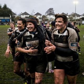 Beth Evans leads her team off the pitch