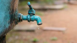 A water tap with a water drop