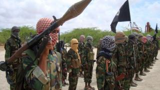 file photo of Thursday Oct.21, 2010, Al-Shabaab fighters display weapons as they conduct military exercises in northern Mogadishu, Somalia.