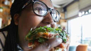 Mulher comendo pizza
