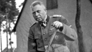 Man in Nazi uniform gardening