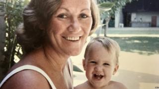 Robyn Hollingsworth as a child held by her mother outdoors