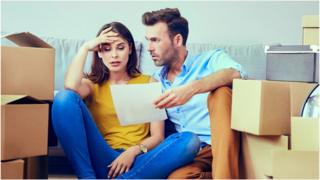 Young couple surrounded by boxes