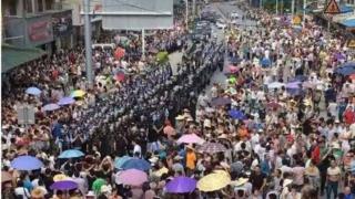 lines of riot police surrounded by residents on a street in China, received by BBC Chinese on 03/07/2016
