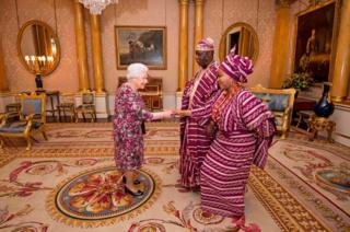 Britain's Queen Elizabeth II greets Nigerian High Commissioner George Adesola Oguntade and his wife Mrs Oguntade