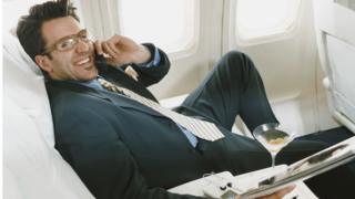 Man on phone on plane