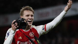 Arsenal's Martin Odegaard celebrates with a camera