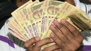 Indian bank customers wait to deposit 500 and 1000 Indian currency notes at a bank in Amritsar on November 10, 2016