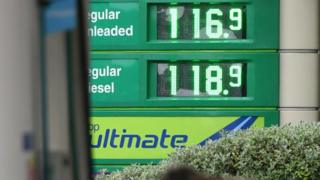 The price of petrol and diesel fuels are shown on an electronic display board outside a BP petrol station in Manchester, north-west England on October 18, 2016