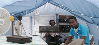 Staff of a local radio station broadcasting from a tent in quake-hit city of Jacmel