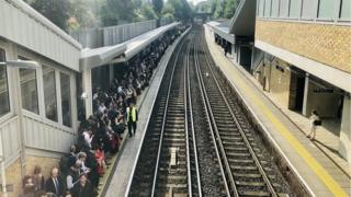 Passengers waiting for trains at Putney