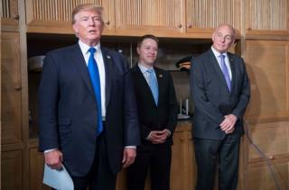 President Trump, White House Deputy National Security Adviser Bo Ming (center) and former White House chief of staff John Kelly (right)