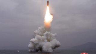 What appears to be a submarine-launched ballistic missile (SLBM) flies in an undisclosed location in this undated picture released by North Korea's official news agency