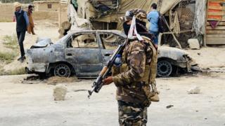 Taliban stands guard near a vehicle which was used to fire rockets at the Hamid Karzai International Airport in Kabul, Afghanistan, 30 August 2021.