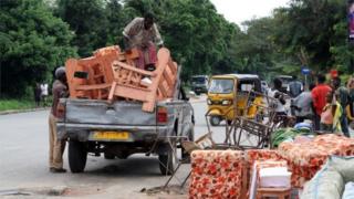 Burundians load belongings on a truck in Bujumbura