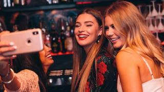 Three girls having a selfie with an iPhone