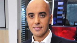 A head and shoulders picture of Redoine Faid in a white shirt and suit