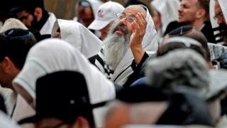 Jewish priests wearing "Talit" prayer shawls take part in the Cohanim prayer (priest's blessing) during the Passover (Pesach) holiday at the Western Wall in the Old City of Jerusalem.