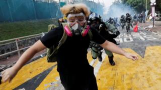 A university student runs from riot police at the Chinese University of Hong Kong, Hong Kong, China