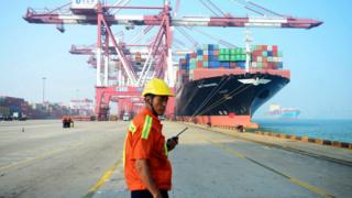 A man stands on a port in China