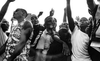 Young men pumping their hands up in the air in defiance