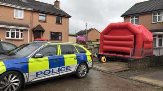 A police car and a bouncy castle