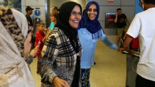 A woman (middle) travelling from Jordan on a Yemeni passport arrives in Los Angeles, California