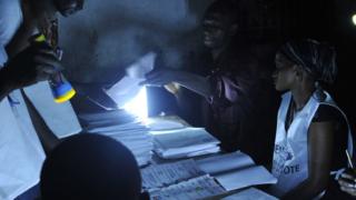 Election officials count votes at a polling station in Conakry on October 11, 2015, during the first round of the country's presidential election in Conakry on October 11, 2015.