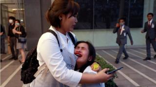 A woman cries at the scene where the fire broke out