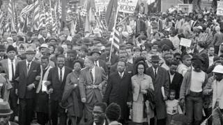 Dr. Martin Luther King (center) leads an estimated 10,00 or more civil rights marchers out on the last leg of their Selma-to Montgomery march - 25 March 1965
