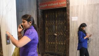 Two women outside closed PNB branch