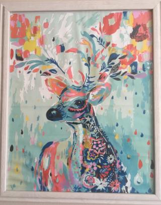 A multicoloured image of a deer created using a painting-by-numbers set