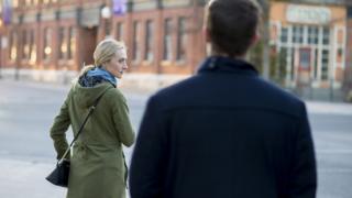 Stock photo of woman looking over her shoulder at a stranger