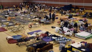 People shelter in a school gym