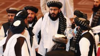 Taliban delegates speak during talks between the Afghan government and Taliban insurgents in Doha, Qatar September 12, 2020
