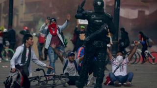 Demonstrators react during a protest at Bolivar Square in Bogota, Colombia