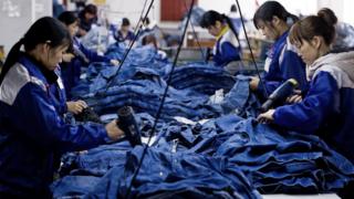 Workers make jeans at a factory Xintang, Guangdong province, China