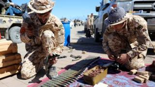Members of Misrata forces sort through ammunition