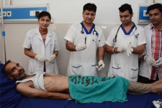 Dr. Jatinder Malhotra (2-L) along with hospital staff displays 40 knives that were removed from the stomach of Surjeet Singh (on bed) with surgery as he recovers at Corporate hospital in Amritsar, India, 23 August 2016