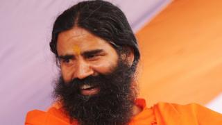 Indian Yoga Guru, Baba Ramdev, greets supporters during a function in Kolkata on April 5, 2013