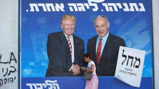 A woman walks past a Likud party election campaign banner showing US President Donald Trump and Israeli Prime Minister Benjamin Netanyahu in Tel Aviv, Israel, on 16 September 2019