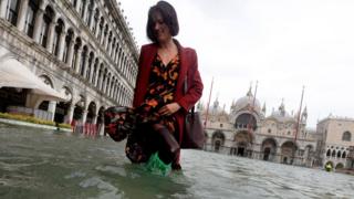 Tourist in flood waters in Venice on October 29, 2018