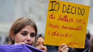 A woman holds a banner reading ''I decide'' during a demonstration in central Rome against a reform of the Spain's abortion law proposed by the conservative government on February 1 , 2014.