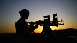 An Afghan soldier behind a machine gun mounted on a vehicle during an operation in October 2019