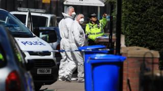 Forensic officers outside the house